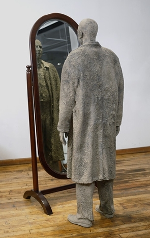 "Man In The Mirror" - Sculpture by James Croak - Photograph courtesy Bernice Steinbaum Gallery - Cast dirt, resin, wood, and mirror - 74" x 48" x 36" - 2005